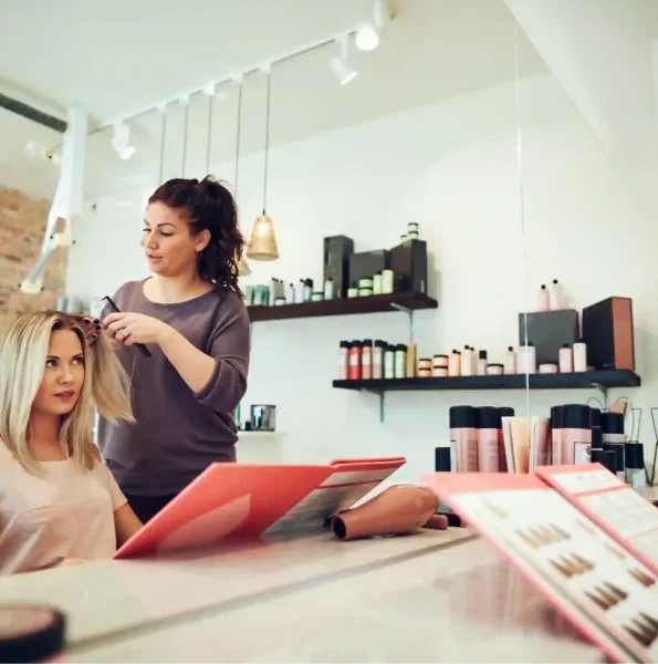 young-woman-looking-at-her-stylist-in-a-salon-mirr-2024-09-16-20-59-25-utc